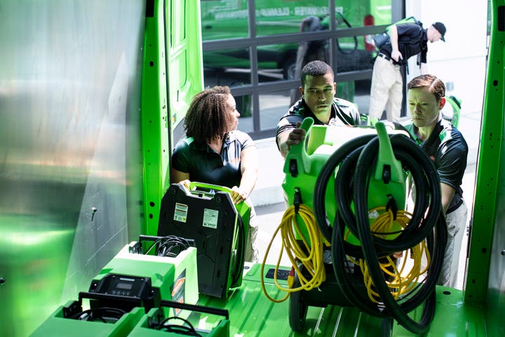 Extra equipment being loaded into SERVPRO truck