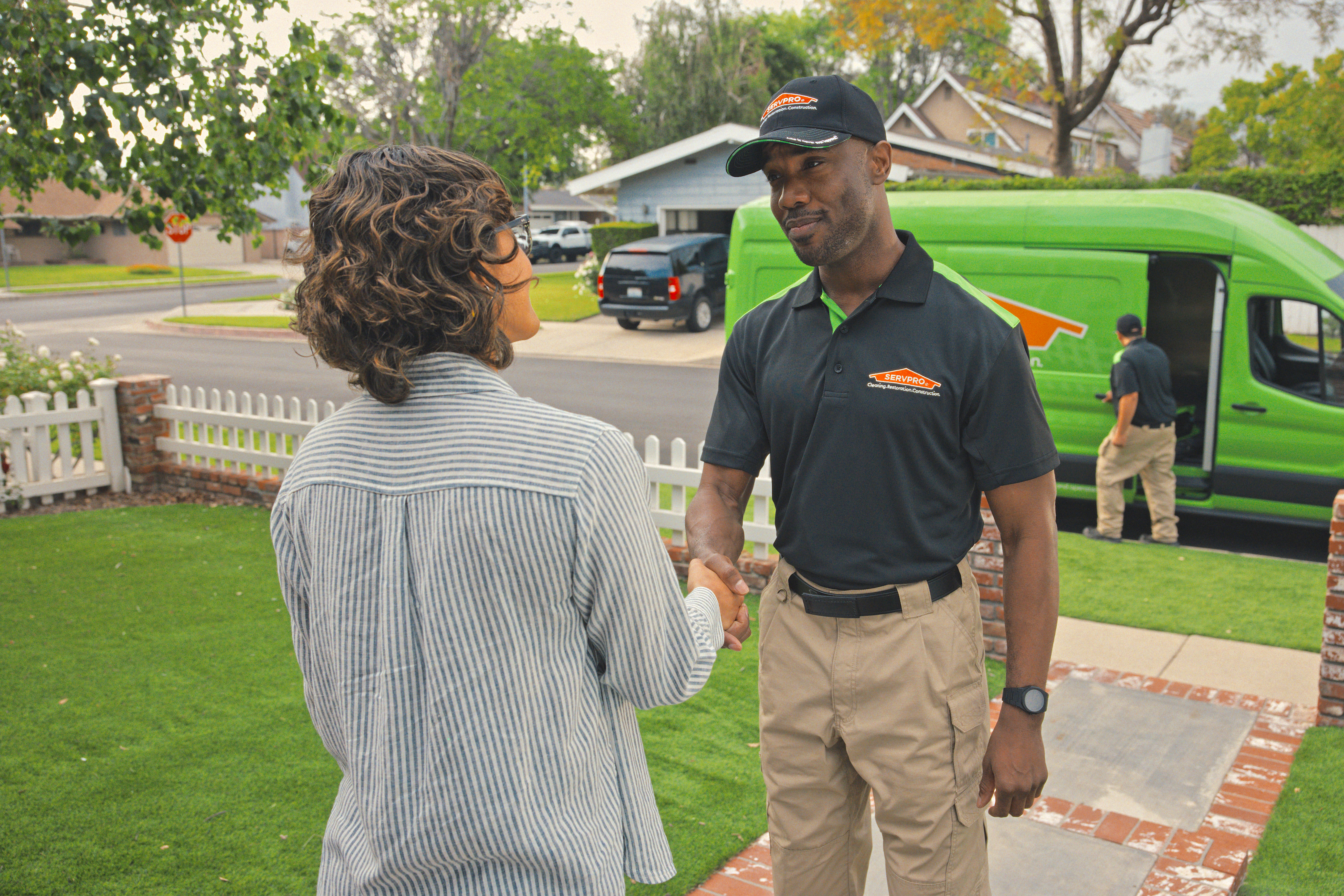 A homeowner and SERVPRO employee shaking each other's hands.